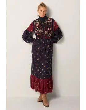 A headturning stunner of a dress by Maison Hotel is a perfect statement, easy and relaxed for this season. The embroidered long dress in tones of navy and red has long sleeves and finished with a frilled hem. The Maxi Length and frilled finish gives it an