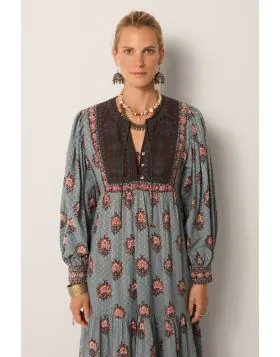A dress that is bound to get you compliments, this Allegra dress does just that. The dress in a rich hand block printed textile in water lillies motifs all over, has a contrast panel, full sleeves with gathered details and the maxi length that sashays wit