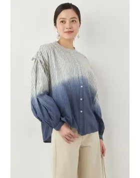 The Summum Dip Dye Blue Striped Blouse offers a sophisticated and modern design for women. It features a figure flattering vertical stripe pattern, while the dip dye effect in shades of blue adds a distinctive touch. The design includes long, slightly puf