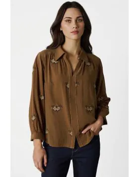 The Tapestry Shirt is a timeless blend of elegance and modern charm, featuring a delicate tonal cross stitched floral embroidery throughout the shirt. Thoughtful details like antique flower button at the neckline, contrast embroidery stitching down the ce
