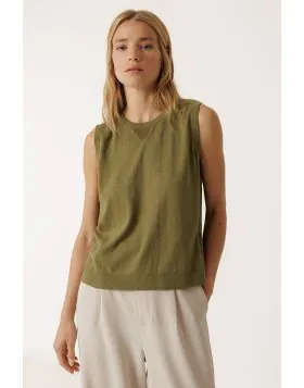 This fine gauge vest is made from organic cotton. It features a fitted shoulder, crew neck, and side vents.  TK507.
