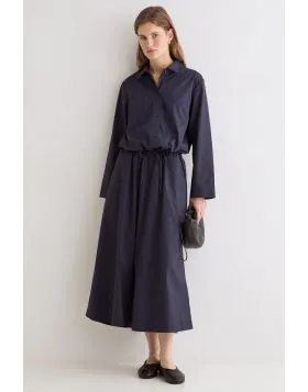 The Yerse Poplin Skirt is an effortless summer staple with a clean, timeless silhouette. Crafted from crisp, lightweight poplin, it features a softly gathered elasticated waistband that sits comfortably on the waist and falls into a relaxed midi length. T
