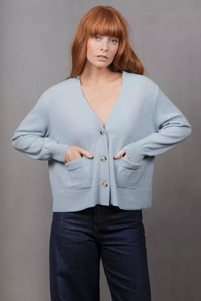 Elevate your layering wardrobe with the V Neck Relaxed Cropped Cardigan, a chic fusion of modern simplicity and cozy comfort. Crafted to be effortlessly versatile, this cardigan features a flattering cropped length and relaxed fit that pairs seamlessly wi