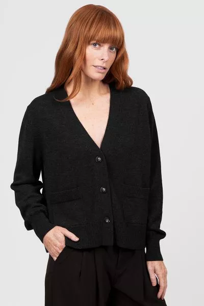 Elevate your layering wardrobe with the V Neck Relaxed Cropped Cardigan, a chic fusion of modern simplicity and cozy comfort. Crafted to be effortlessly versatile, this cardigan features a flattering cropped length and relaxed fit that pairs seamlessly wi