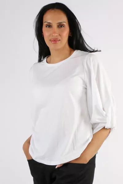 An easy white top is a summer staple and this one fits the bill perfectly. In a round neck and 3/4 sleeves, the the statement gathered sleeve design gives it a little something extra. Style it with easy pants or skirts. 5850.
