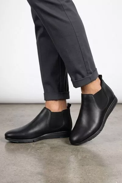 this fusion urban boot offers a sleek, minimalist aesthetic combined with all day comfort for the modern professional. These black leather Chelsea style low rise boots feature a flexible sole and elastic side panels that ensure a perfect fit for any urban