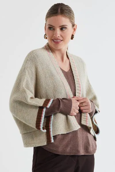 Introducing the Lofty Shrug. This easy fit shrug features contrast tipping for a touch of modern elegance. Made from high quality materials, it offers a comfortable and flattering fit. Perfect for any occasion, from casual outings to formal events. LC7177