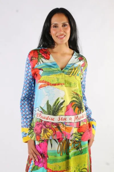 V-neck button down loose fitting top with long sleeves in our Twisted Love print. Hemline is rounded. Body of the shirt is a beautiful tropical landscape with flowers, palm trees and water. It says “Me” and “Paradise State of Mind”. Predominant colors are
