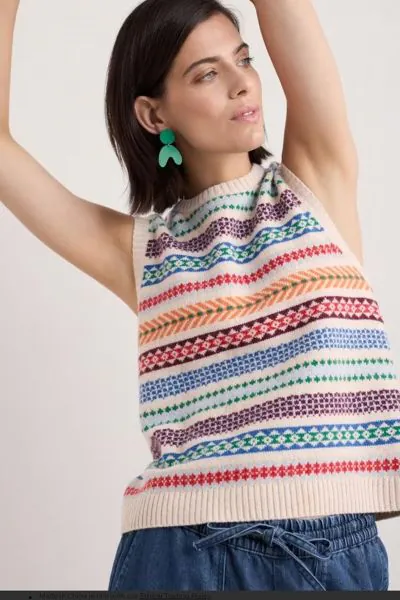 A joyful, vintage inspired sweater vest, knitted from a blend of soft merino and recycled fibres for durability. The geometric pattern was created by our knitwear designer with shapes and bright accents inspired by fairy lights and festive baubles. Its th