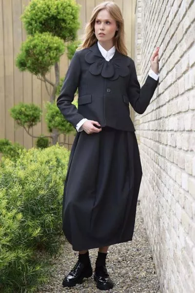 Commanding attention with its tulip silhouette, the SUIT CAMP Skirt is a modern take on tailored dressing. Crafted in SUITS UP fabric, this panelled design features curved seam panels that tuck inwards for a flattering drape, while a fixed waistband with 
