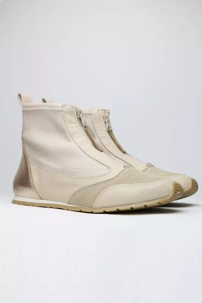 Sleek and sophisticated, this Istra Sneaker Boot by Zeta is a perfect go to for the season. The soft wedge boot has a front zip top in a combination of nylon and leather. Style this Sneaker boot with separates or add an edge to your dresses. 