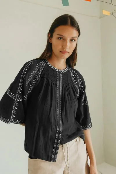 Effortless boho chic meets everyday comfort. Crafted from lightweight, breathable cotton, this shirt features beautiful contrasting ethnic embroidery that adds a touch of artisan charm to your wardrobe. Romantic bell sleeves, delicate shoulder pleats, and