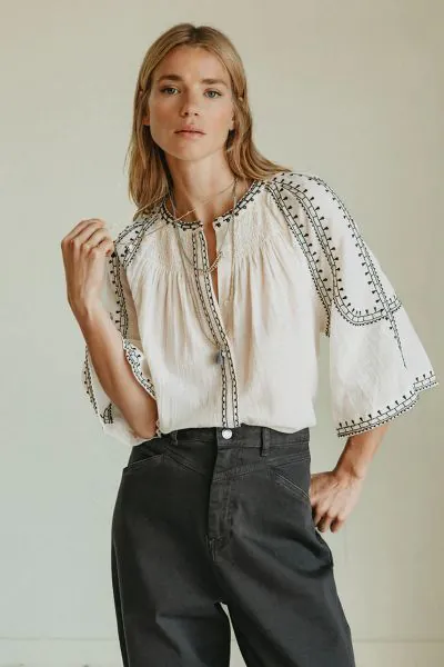 Effortless boho chic meets everyday comfort. Crafted from lightweight, breathable cotton, this shirt features beautiful contrasting ethnic embroidery that adds a touch of artisan charm to your wardrobe. Romantic bell sleeves, delicate shoulder pleats, and