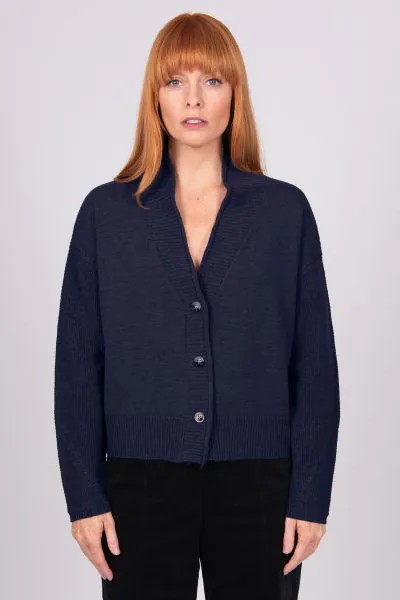 A Boxy fit relaxed cardigan with ribbed shawl collar and detailed, cable panel feature. Dropped shoulders for an easy to wear, relaxed look. High hip length. The collar can be worn high or folded for a roll collar effect. Horn-look buttons for a stylish f