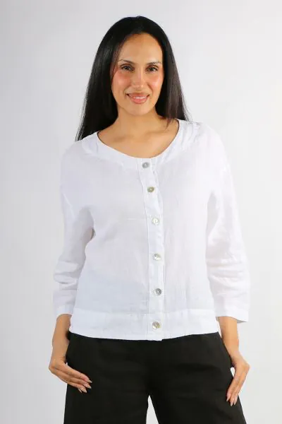 This lightweight linen jacket is designed with a relaxed boxy silhouette that layers easily over dresses, tanks, and everyday separates. Drop shoulders and soft long sleeves create an easy drape, while the round neckline and button front closure keep the 