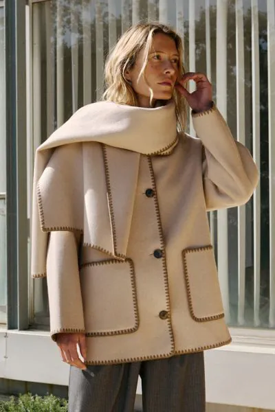 If you like small details, this wool coat with an added scarf is made for you. All the finishes on this garment are hand embroidered, and its regular fit looks great. BY606.

