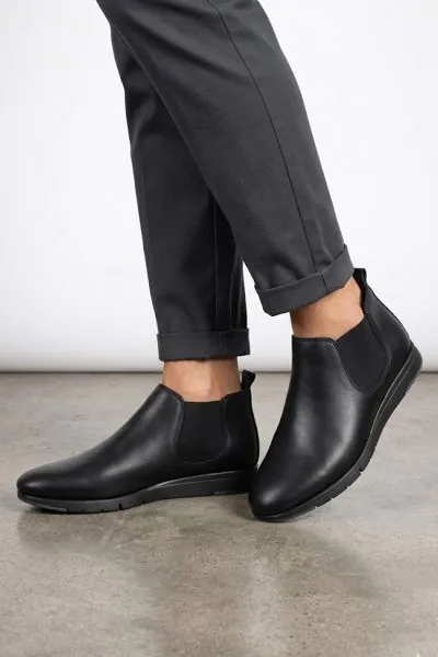 this fusion urban boot offers a sleek, minimalist aesthetic combined with all day comfort for the modern professional. These black leather Chelsea style low rise boots feature a flexible sole and elastic side panels that ensure a perfect fit for any urban