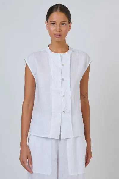 Minimal with a quietly interesting twist. This GA688 sleeveless linen top features a rounded collarless neckline and a textured quilted-panel placket with buttons, set into a relaxed, boxy fit with extended cap shoulders. The clean yoke detail at the back