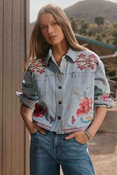 The Talulla Cropped Denim Jacket is crafted from 100% breathable cotton and is embellished with colorful floral embroidered detailing. Designed with a collared button front and distinctive yoke, this relaxed-fit cropped jacket is finished with a straight 