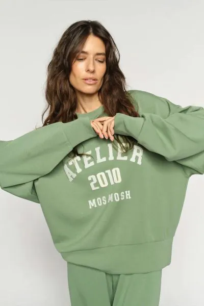 A soft, oversized sweatshirt with a casual yet refined look. Designed with a round neckline, ribbed trims, and a bold front print for a sporty edge. The fabric blend feels smooth and comfortable, making it perfect for laid-back days or styled with tailore