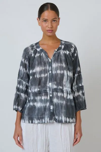 A blouse that does more than just fit its a statement. The P161 combines bohemian charm with refined detailing through its delicate pintuck pleating and a button front design, complemented by cropped balloon sleeves and a shirred neckline for a touch of f