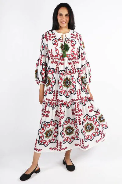 Pearl and Caviar s maxi dress reflects unique character with Its bubble sleeves, and jewel neckline with tassels. Artisanally handcrafted in Greece, the relaxed fit maxi has a tiered construction that is highlighted with an array of intricately handwoven 