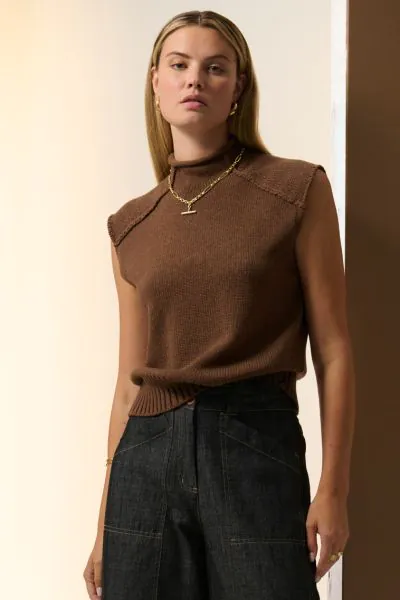 With a funnel neckline and a sleeveless design, the Sable Knit Tank is an elevated knit top perfect for transseasonal wear. Full neckline and rolled edge. STYLE PP5652.