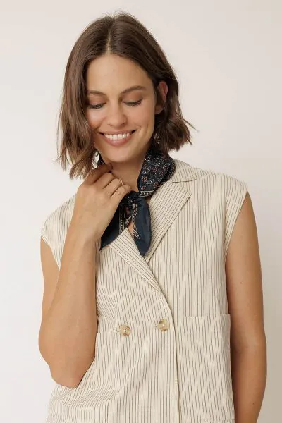 This scarf will elevate all your looks. It is made from organic cotton and features a block print with a floral border. RG657.
