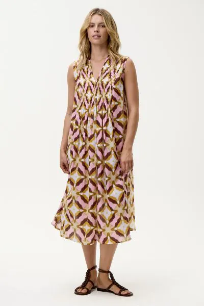 The Tobago Tommy Dress from oneseason captures the carefree essence of sun drenched days with a distinctly feminine edge. Crafted from lightweight, breathable cotton, this sleeveless silhouette is designed with a flattering V neckline and delicate pintuck