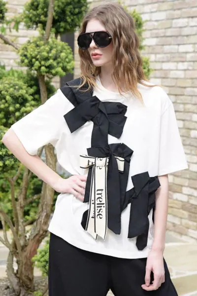 Playful yet polished, the PRESENT DREAMS T shirt from Trelise Cooper makes a subtle statement. Made from COTTON S UP cotton t shirting, it is finished with a fixed grosgrain bow embellishment that adds a touch of charm to its easy silhouette. Playful with