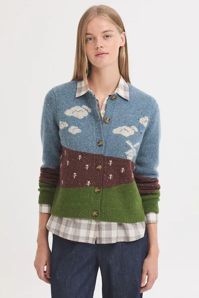 Inspired by the peaceful charm of the Dutch countryside, this cozy knit sweater captures a scenic landscape of Holland complete with rolling green fields, soft blue skies, and a classic windmill standing quietly in the distance. Rendered in shades of gree