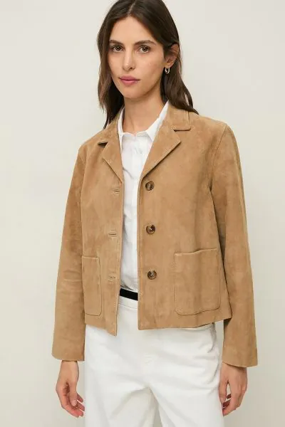 A short jacket crafted from soft, velvety goatskin suede. Designed with a classic silhouette, it features lapels, a button front closure, and patch pockets for a refined yet effortless look. Fully lined for comfort, it is an elegant layering piece for eve