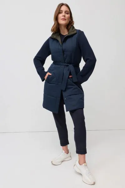 The Reversible Belted Vest is a versatile layering piece designed for warmth through the cooler months. Quilted for a modern puffer inspired look, it features a sleeveless cut, press stud front and a matching waist tie that can be cinched to shape the sil