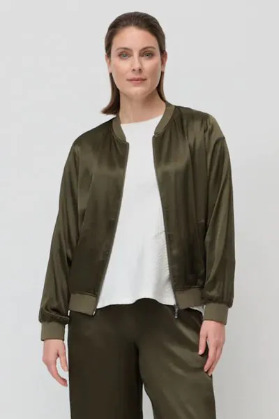 The After Hours Bomber is a relaxed fit jacket crafted from lustrous viscose with a subtle sheen for a modern edge. Designed in a classic bomber silhouette with a ribbed neckband and cuffs, functional front pockets and a zip through front, it is an effort