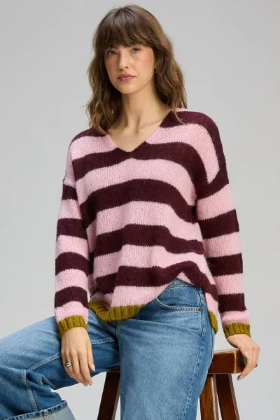 This striped knit jumper brings a playful yet refined touch to everyday dressing. Featuring bold horizontal stripes in soft pink and rich burgundy, its finished with subtle contrast trims at the cuffs and hem for an added pop of colour. Zp8140.