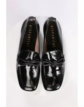 An elegant square toe moccasin made from a soft leather upper with a leather bow embellishment over the instep. Slip on and off with ease. Perfect for work, or for an elevated casual look. European sizing. Made in Spain. Leather upper, microfibre lining, 