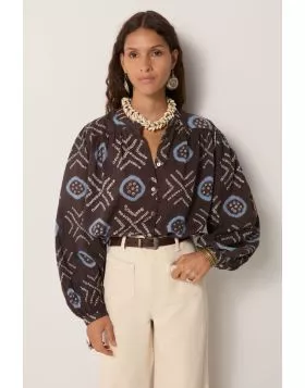 100% cotton voile blouse, cut loose with a soft drape, patterned in hand dyed geometrics. Circles framed in sky blue and dotted crosses run across a dark ground, the irregularity of each mark carrying the imperfect rhythm of craft. The voile is airy and t