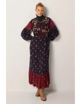 A headturning stunner of a dress by Maison Hotel is a perfect statement, easy and relaxed for this season. The embroidered long dress in tones of navy and red has long sleeves and finished with a frilled hem. The Maxi Length and frilled finish gives it an