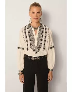 Strut your fashionable stuff everyday with Maison Hotel Bruna Orchid Shirt. The textured cotton shirt has a beautiful and stunning embroidered front along with long sleeves. Style this deluxe shirt with easy high waisted pants and assorted jewels with mes