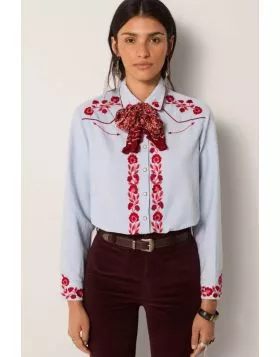 A soft sky blue cotton lends this shirt a smooth, light texture, tailored into a modern cut that balances sharpness with ease.Striking red floral embroidery covers the chest, cuffs and button placket, while snap buttons underline its Western reference. Th