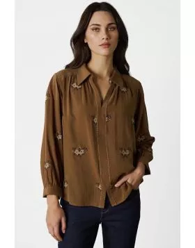 The Tapestry Shirt is a timeless blend of elegance and modern charm, featuring a delicate tonal cross stitched floral embroidery throughout the shirt. Thoughtful details like antique flower button at the neckline, contrast embroidery stitching down the ce